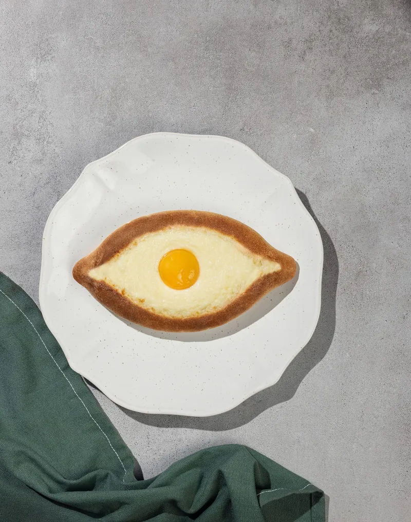 Freshly baked Chizzzy Acharuli Khachapuri on a plate